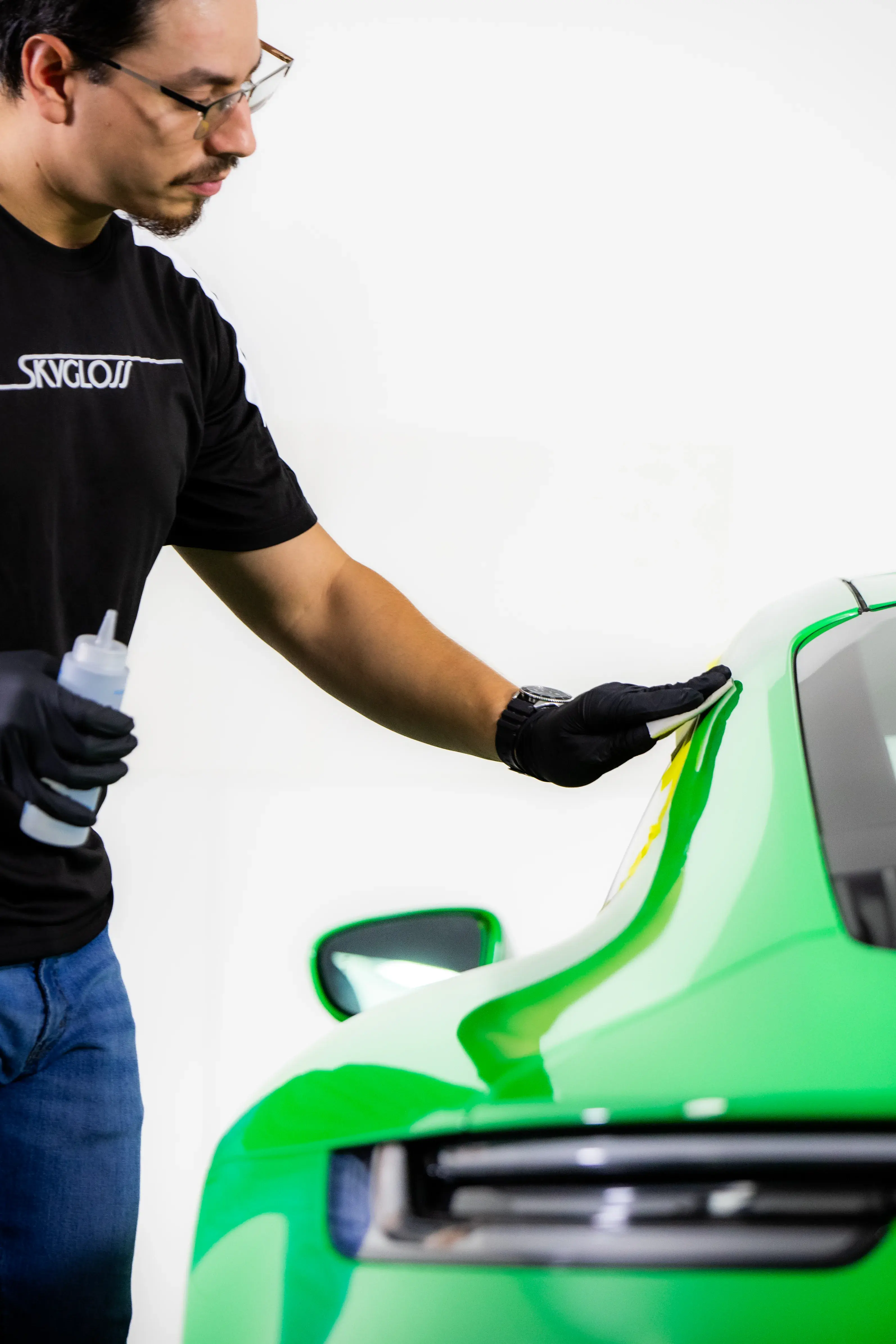 A SkyGloss technician working on a vehicle finish
