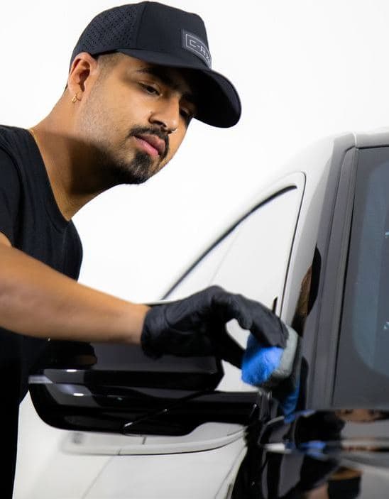 A SkyGloss technician inspecting a car