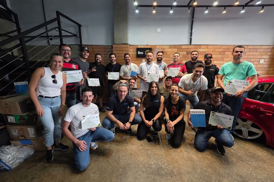 Technicians holding their SkyGloss certificates after training